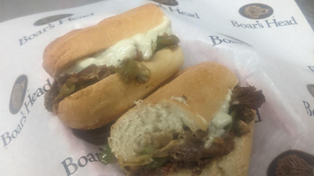 Green Chile Philly · Spicy. Sliced choice ribeye steak, mushrooms, green bells, onion, green chile, white American cheese.