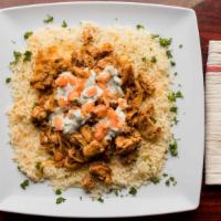 Chicken Shawarma Over Rice · Slices of chicken grilled with onions, olive oil and garlic, over a bed of rice, topped with...