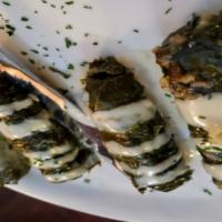 Vegetarian Grape Leaves · Handmade in our kitchen. Grape leaves, stuffed with rice, tomatoes, parsley and spices. Serv...