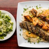 Combination Skewer Over Rice · The house favorite. Three charbroiled kabobs skewers of lamb, chicken and kafta served on a ...