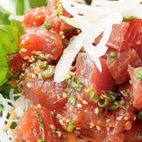 Spicy Hawaiian Poke Salad · Hot. Fresh tuna poke over a bed of green leaf lettuce, slice white onion, seaweed, and cucum...