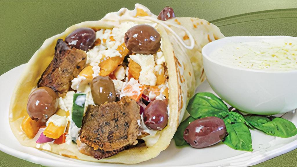 Traditional Gyro · Freshly made pita bread served 'Santorini-style,' stuffed with fries.  

Filled with our signature juicy beef and lamb gyro meat.  Topped with feta cheese, tomatoes, onions, cucumbers, kalamata olives.  

Served with a side of our in-house, freshly made, zesty Tzatziki sauce.