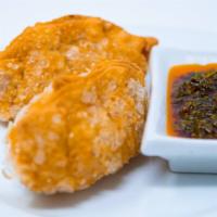 Empanadas · Two savory beef or chicken turnovers served with argentine chimichurri sauce.