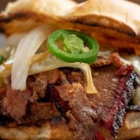 The Bevo · Beef brisket, coleslaw, grilled bell peppers, red, & onion topped w/ BBQ sauce.