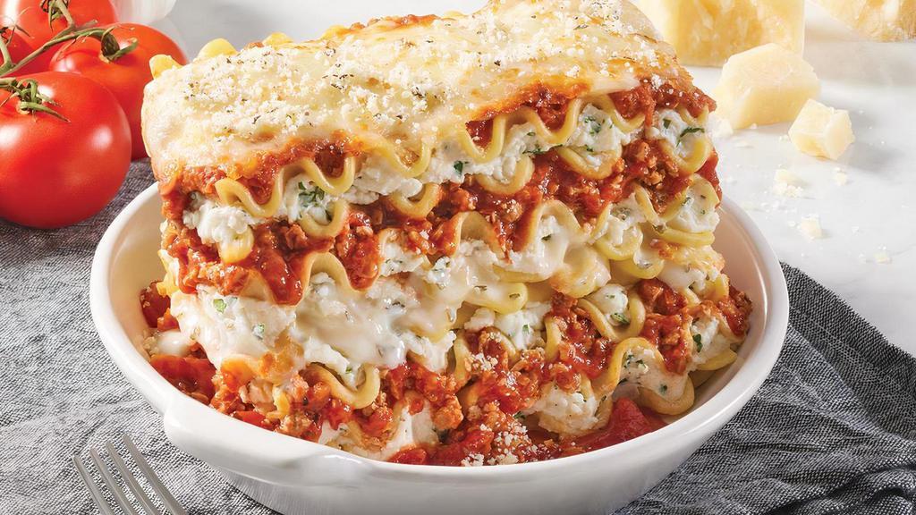 Cheesy Double-Stack Lasagna · A towering 18 total layers of pasta, ricotta, meat sauce, mozzarella, provolone, and parmesan.