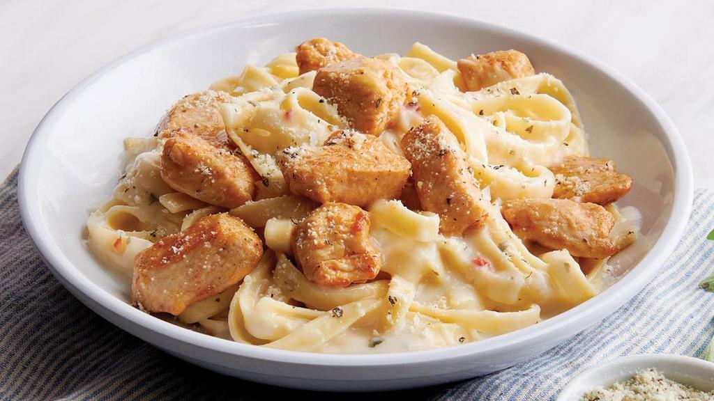 Chicken Fettuccine Alfredo · Fettuccine topped with creamy garlic and. parmesan Alfredo sauce topped with shaved Parmesan and oven-roasted chicken breast meat.. Includes 2 of our Signature Garlic Breadsticks