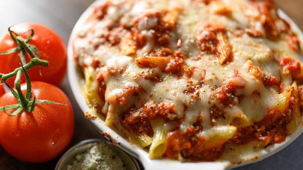 Baked Ziti · Penne with Meat Sauce topped with Mozzarella and Provolone Cheeses and baked to a golden, bubbly perfection.. Includes 2 of our Signature Garlic Breadsticks. If you're looking to add an additional side or toppings, please visit the Sides/Extras section of the menu.