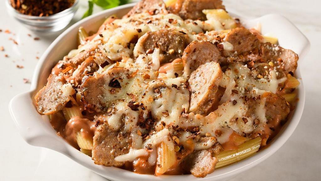 Spicy Baked Ziti With Sausage · Penne pasta topped with spicy tomato pepper sauce, Italian sausage, and baked with mozzarella and provolone cheeses. Includes 2 of our Signature Garlic Breadsticks