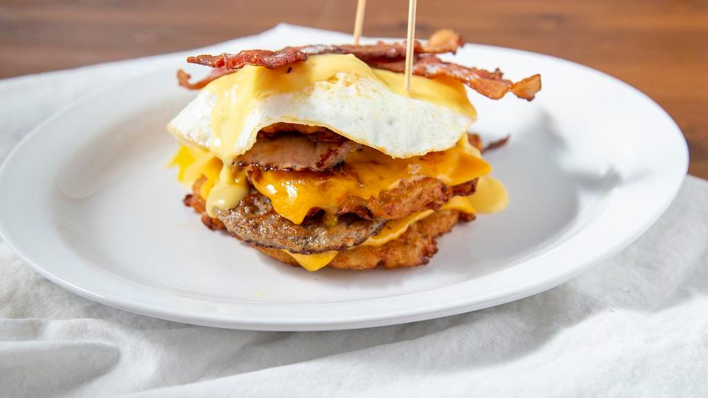 Am Pile Up Am · Three of our famous potato pancakes piled high with two eggs, bacon, ham, sausage, cheddar, american and a drizzle of house made cheesy hollandaise sauce.