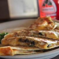 The Quesadilla · Five cheese deep dish quesadilla crisped to perfection. Filled with black beans, onions, cil...