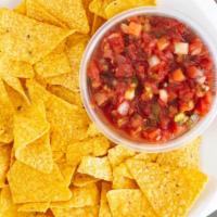 Chips & Salsa · Freshly made in house corn tortilla chips served with green tomatillo salsa and red salsa.