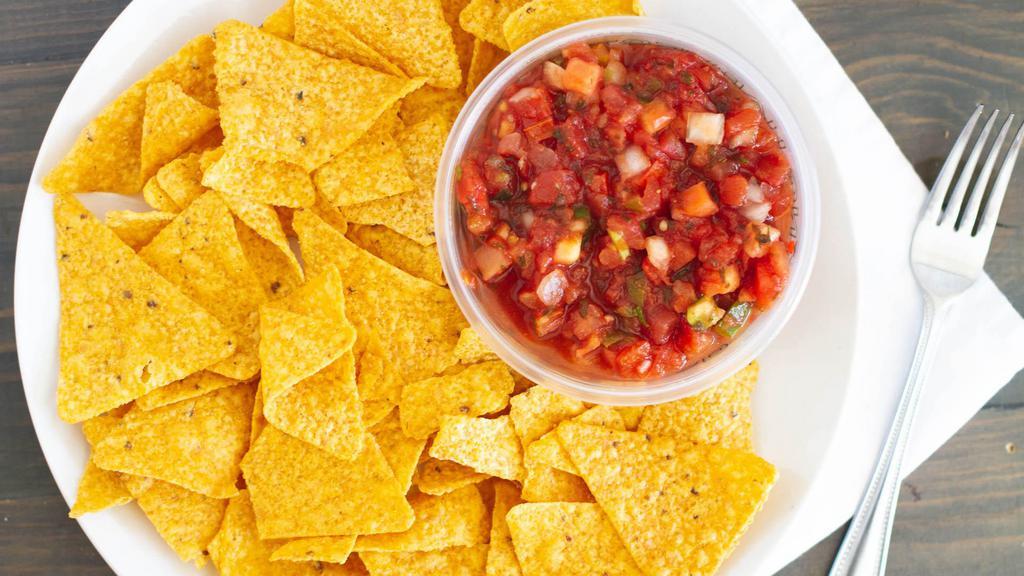 Chips & Salsa · Freshly made in house corn tortilla chips served with green tomatillo salsa and red salsa.