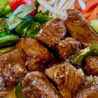 Luc Lac (Shaking Beef Cube ) · 8oz of filet mignon beef stir fried with special house sauce, bell pepper and onion over let...