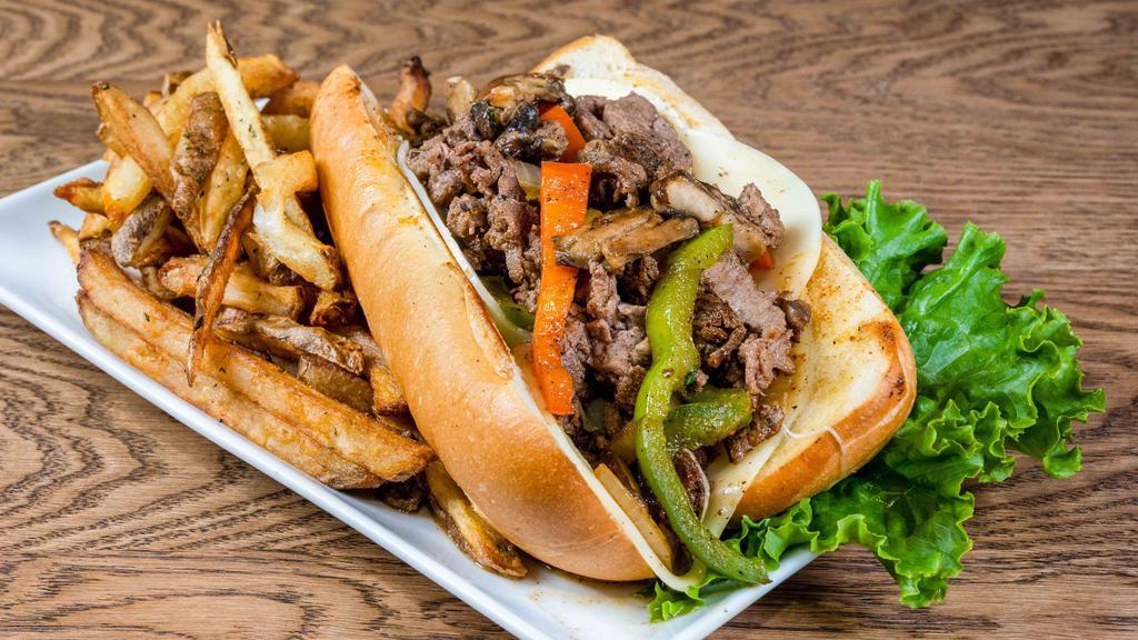 Philly Steak Sandwich · Grilled tender steak smothered with green peppers, mushrooms, onions and topped with melted provolone cheese on a toasted roll with mayo.