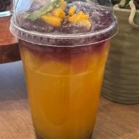 Mango Sunset · Taste of mango is blended with quality syrup and beautifully iced top with butterfly tea pro...