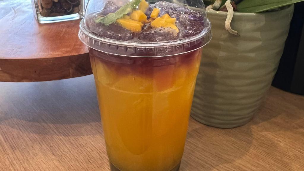 Mango Sunset · Taste of mango is blended with quality syrup and beautifully iced top with butterfly tea provide a natural scene of summer sunset. Serve with large 24 oz size