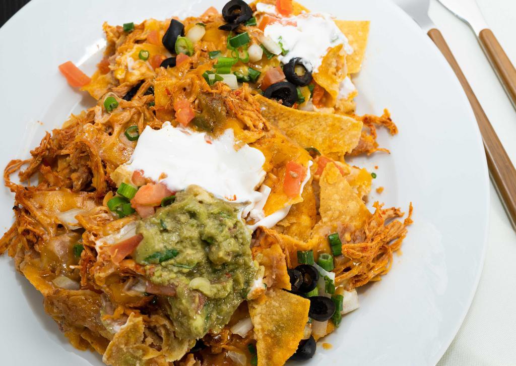 Nachos Casamigos · Top menu item. Includes your choice of chorizo, ground beef, chicken, melted cheese garnished with tomatoes, onions, black olives, guacamole and sour cream.