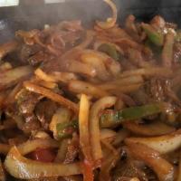 Steak Fajita · Marinated in our secret sauce, then delivered sizzling hot over a bed of sauteed onions and ...
