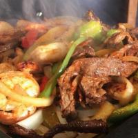 Trio Fajitas · Chicken, steak and shrimp. Marinated in our secret sauce, then delivered sizzling hot over a...