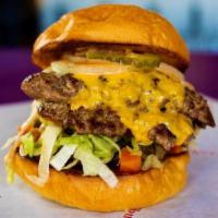 Hot Island Burger · Made with American & Swiss cheese, 1000 Island, Hot Peppers, Lettuce, Valentina, Onion & Pic...