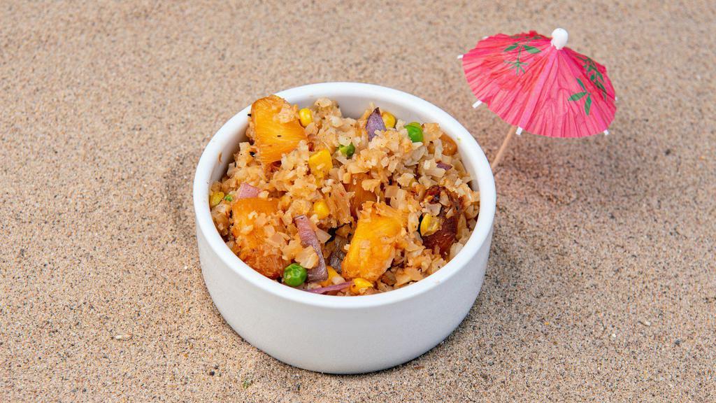 Pineapple Cauliflower Fried Rice · Roasted cauliflower rice, chili-dusted pineapple, peas, corn, green onions, and sesame seeds with our house-made ginger garlic sauce and a protein of your choice. (Gluten-free)