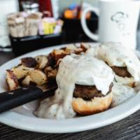 Country Benedict · Our buttermilk biscuit split then topped with sausage patties, two poached eggs & our savory...