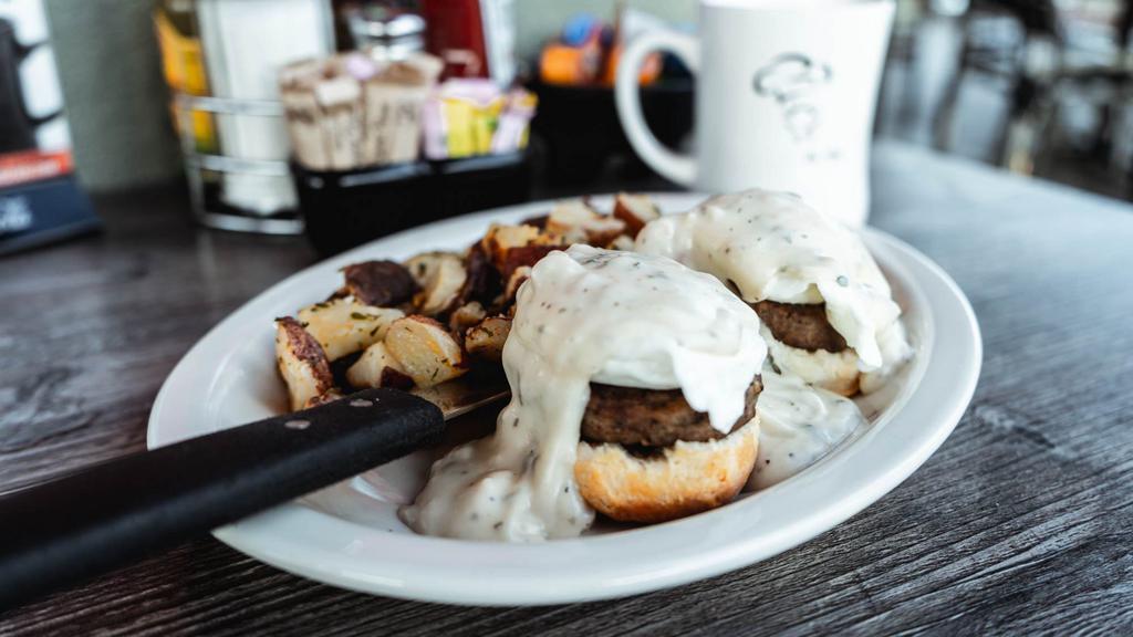 Country Benedict · Our buttermilk biscuit split then topped with sausage patties, two poached eggs & our savory sausage gravy.
