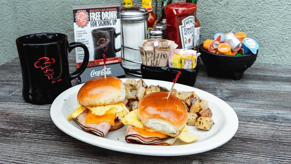 Breakfast Sliders Combo · Two sliders topped with your choice of ham, bacon or sausage; each topped with an egg* cooked to your liking & cheddar cheese on our premium brioche bun.