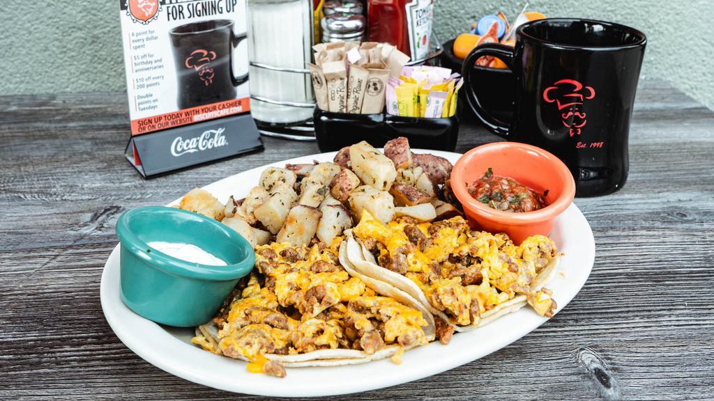 Breakfast Tacos · Scrambled eggs with your choice of taco meat, ham, bacon, sausage or chorizo on warm corn tortillas topped with cheddar cheese. Served with sour cream & salsa.