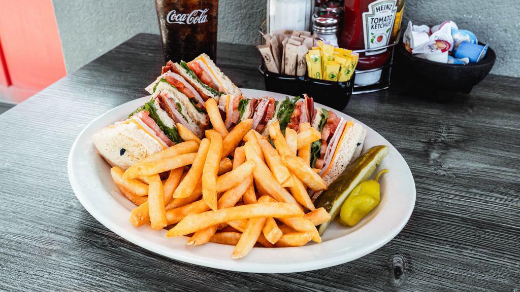 Classic Club · Triple decker sandwich with sliced turkey, ham, bacon, mild cheddar cheese, lettuce, tomato & mayonnaise.
