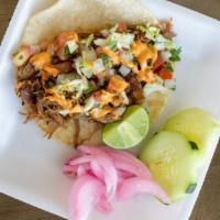 Puerco Con Chile Taco · Pork cooked low and slow with three types of chiles on a tortilla with pico cabbage and chip...