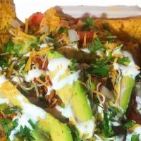 Nachos · Served with corn chips, pinto beans, cheese, nacho cheese sauce, diced tomato, avocado, guac...