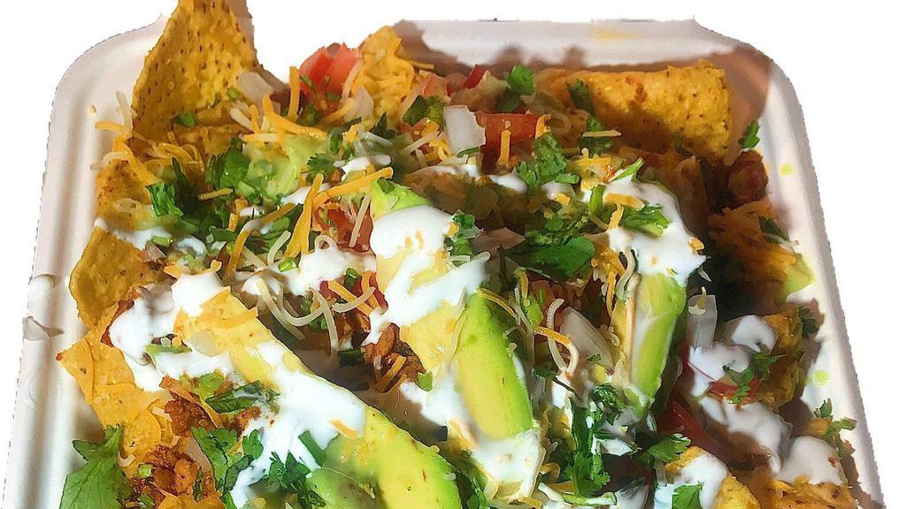 Nachos · Served with corn chips, pinto beans, cheese, nacho cheese sauce, diced tomato, avocado, guacamole and sour cream.