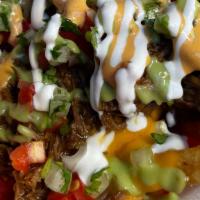 Loaded Fries · Deep fried steak fries topped with nacho cheese, your choice of asada, al pastor, birria or ...