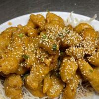 Sesame Chicken 芝鸡 · Deep fried white meat chicken with ginger candy coating.