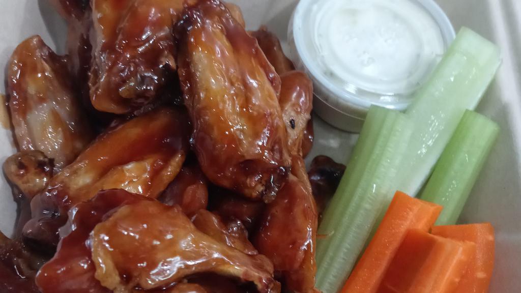 Chicken Wings 10 Piece · Choice of sauce: Buffalo, pineapple habanero, drunken teriyaki, BBQ, Ghost Chile, Garlic Parmesan or lemon pepper. Comes with celery and carrots choice of ranch or blue cheese.