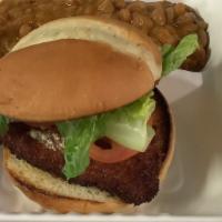 Fried Chicken Sandwich · Fried hand breaded chicken breast on a bun with choice of sauce, and lettuce and tomato. Com...