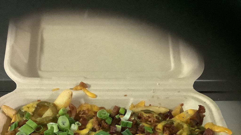 Loaded Fries · Crispy fries topped with melted cheese, bacon, jalapenos, and scallions.