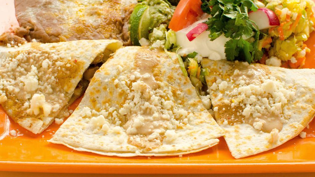 Quesadillas · Flour tortilla filled with melted cheese, onions, tomatoes, and jalapenos. Sour cream and guacamole.