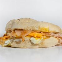 Manorville Breakfast Sandwich · Sliced TURKEY breast, 2 eggs, and melted American cheese on a Kaiser roll, with butter, salt...
