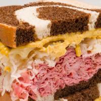 Rockefeller Reuben Sandwich · Hot. Pastrami or turkey, swiss, sauerkraut, spicy mustard, or Russian dressing on rye.
