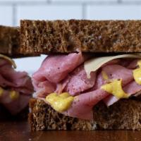 Corned Beef On Rye Sandwich · Corned beef and spicy mustard or Russian dressing butter on rye. Served hot with a pickle sp...