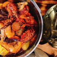 Louisiana Seafood Boil · Crawfish, head on shrimp, mussel, clam, andouille sausage, corn, baby red potatoes, Cajun re...