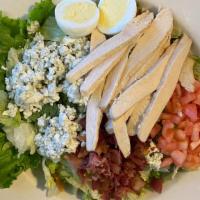 Cobb Salad · Crisp greens, tender grilled chicken breast bacon, tomatoes, crumbled bleu cheese, and a har...