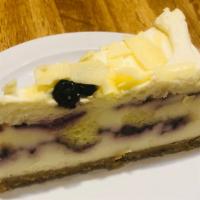 White Chocolate Blueberry Cheesecake · A white chocolate cheesecake with a salted graham cracker crust, filled with blueberry sauce...