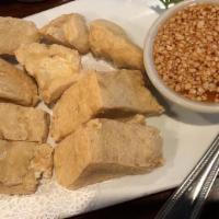 Fried Tofu · Vegetarian, gluten free. Deep fried tofu topped with Thai herbs served with sweet & sour pea...