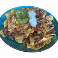 Nachos · Tortilla chips topped with refried beans, cheese, pico de gallo, sour cream and guacamole,ch...