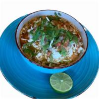 Pozole · Simmered bone-in pork and hominy in a New Mexico chile broth. Topped with shredded cabbage, ...