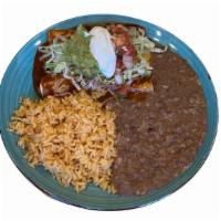 Enchiladas · Two enchiladas corn tortilla red sauce cheese lettuce pico de gallo cream and guacamole serv...