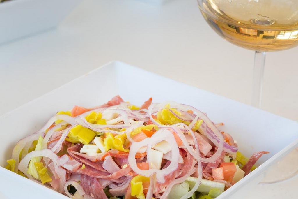 Italian Chopped Salad · Black forest ham, capocollo, geno salami, pepperoncini, tomato, onion, provolone, romaine, chipotle vinaigrette